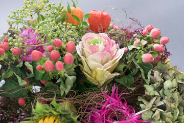 bouquet of ornamental cabbage, ivy blossom, pink rose and sunflowe, faded