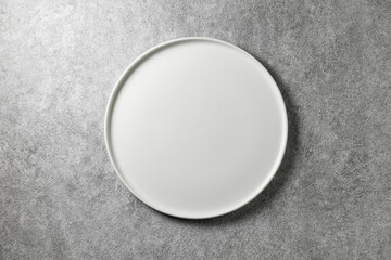 beautiful white plate on gray concrete background, top view
