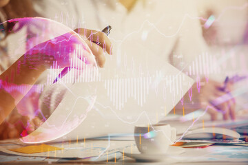 Naklejka premium Double exposure of forex graph drawing over people taking notes background. Concept of financial analysis