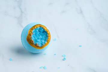 Bath bomb with sea salt crystals on a white background. High quality photo