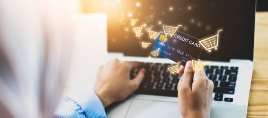 Woman using Credit card filling in billing information in computer laptop purchasing products on ecommerce store online payment shopping, selective focus, accessible internet money transaction