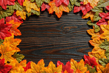 Naklejka na ściany i meble multicolored autumn maple leaves on a wooden background. Place for text