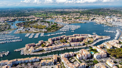 Obraz premium Aerial view of the Cap d'Agde sea resort on the South of France along the Mediterranean Sea - Artificial island in the marina with touristical amenities