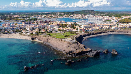 Aerial view of the Cap d'Agde sea resort on the South of France along the Mediterranean Sea - Rocky cape from above