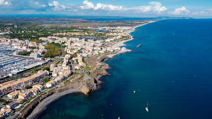 Aerial view of the Cap d'Agde sea resort on the South of France along the Mediterranean Sea - Coastline looking east