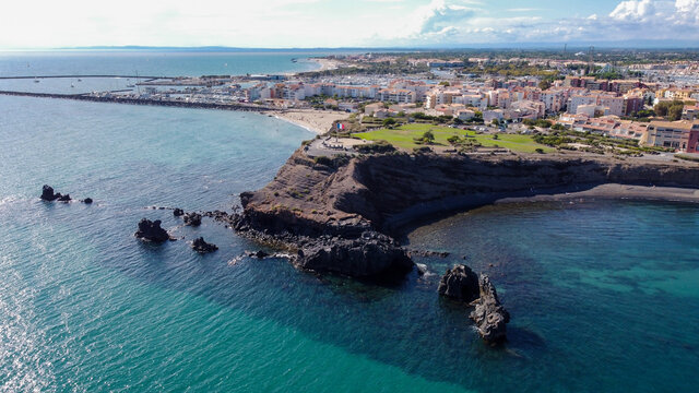 Aerial view of the Cap d'Agde sea resort on the South of France along the Mediterranean Sea - Rocky cape from above