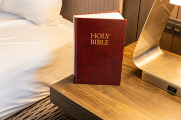 Bible in hotel room on bedside table