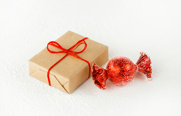 
Christmas gift box in craft paper with candy.
