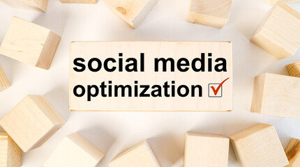 SMO.SOCIAL MEDIA OPTIMIZATION. Text on wood block on light background