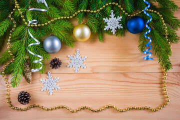 Fototapeta na wymiar Wooden Christmas background with fir branches, Christmas balls, garlands and decorations