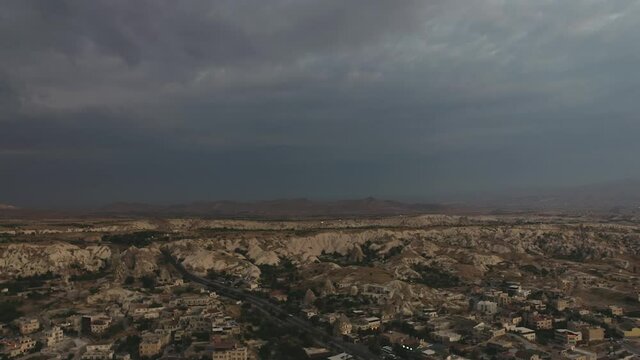 The drone takes off in the morning before dawn in a very gloomy cloudy weather in Cappadocia, very beautiful and unusual residential caves.