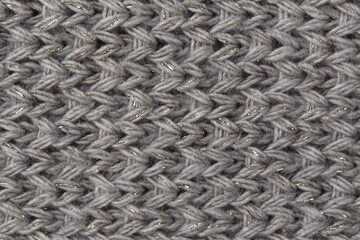 Brown knitted wool texture background with gold thread.