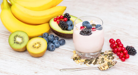 Group Fruits Breakfast with bread Whole grains and nuts, yogurt mix with Cherry , banana, avocado in the wooden table. Breakfast for Health and Diet concept