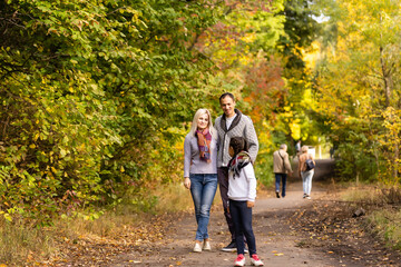 Fototapeta premium happy family walking in the autumn park