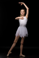 Fototapeta premium Full length portrait of a charming gymnast girl in elegant dress.