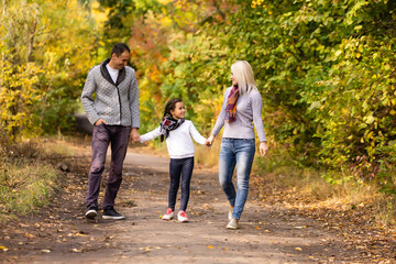 Fototapeta premium happy family Walking through autumn park