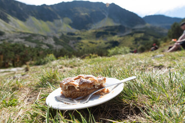 Szarlotka - type of apple pie - eaten in front of tartra mountains landscape, mountain tourist rest and eating, Szarlotka jedzona w Tatrach, Tatry - obrazy, fototapety, plakaty