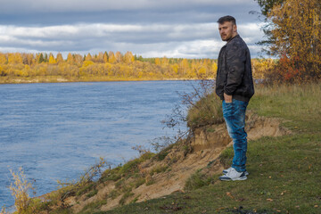 Fototapeta premium Lonely man on the beach during sunset.