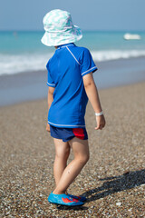 little child walking on the beach