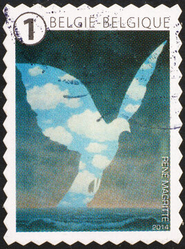 Surrealistic painting by Magritte on belgian stamp