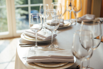 Luxurious restaurant. Luxurious interior, white tables, serving dishes and glasses for guests