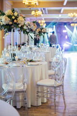 A beautiful vase of flowers on a table in a luxury restaurant. Wedding decorations