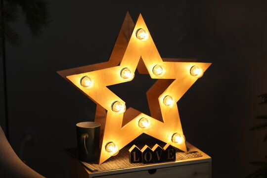 Photo of a golden star with light bulbs