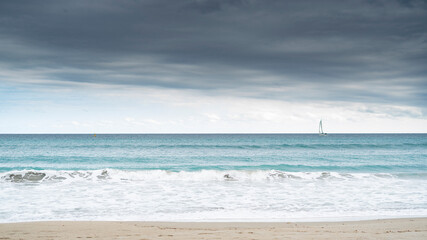 Fototapeta na wymiar poetto beach with a sailboat. Freedom concept