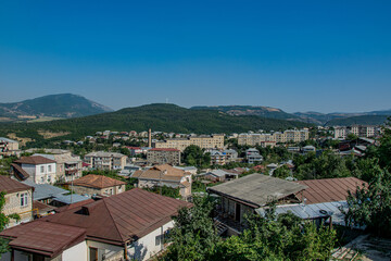 Fototapeta na wymiar Stepanakert, Artsakh (Nagorno-Karabakh), 7 August 2017. View across the roofs of Stepanakert towards the mountainous landscape in which the capital is situated.