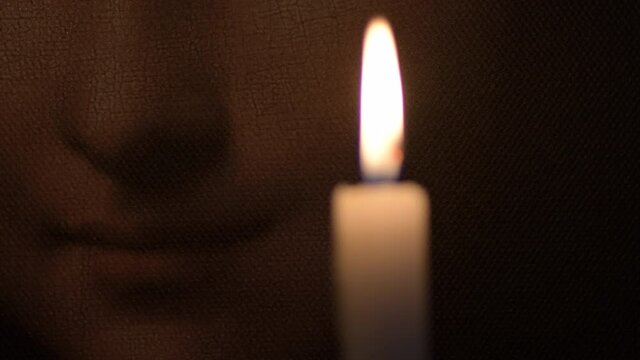 Smile of Gioconda o Mona Lisa illuminated with a candle