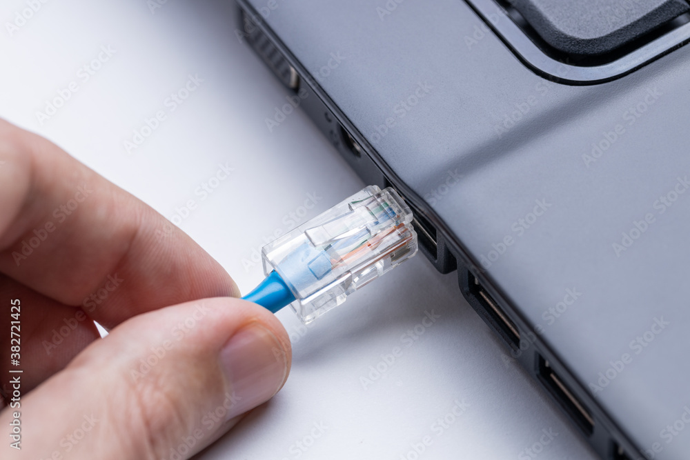 Aufkleber person plugging internet ethernet cable to laptop pc. online and network access conceptual. internet
