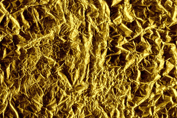 Gold shiny wall abstract background. Crumpled luxury metallic foil texture.