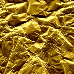 Gold shiny wall abstract background. Crumpled luxury metallic foil texture.