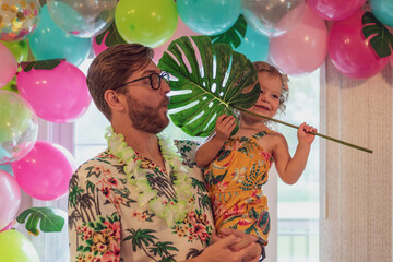 Daddy and daughter at a tropical theme birthday party at home
