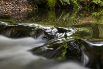 Naklejka na ściany i meble waterfall in the forest, long exposure with blurred motion