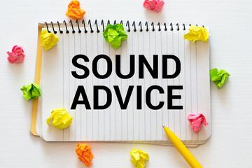 Sound Advice: Typed Words On a handbook with note book, marker pen and notebook.
