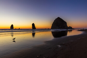 Dramatic sunset on the beach with Haystack rock and the needles