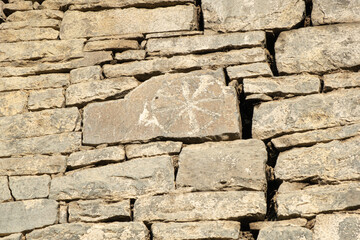 Ancient petroglyphs on the stone walls of an old house, drawings on stones Russia Dagestan