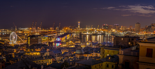 Genoa, Italy - 09 19 2020: Genoa harbor from Spianata Castelletto by night. 