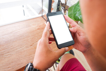 Mockup picture of business woman’s hands/man's hands holding smart phone with white blank screen in modern place.