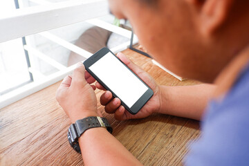 Mockup picture of business woman’s hands/man's hands holding smart phone with white blank screen in modern place.