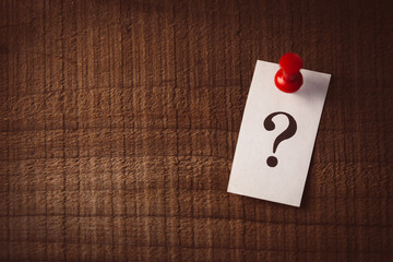 Question Mark Paper Pinned On Wooden Background