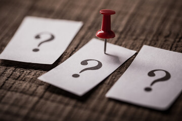 Question Mark Paper Pinned On Wooden Background