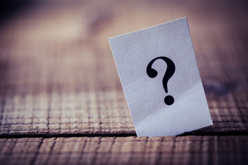 Question Mark Paper Stand On Wooden Background