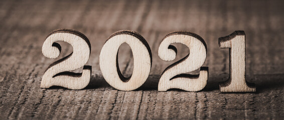 Year 2021 wooden numbers on wooden background