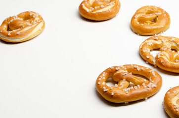 Different tasty homemade pretzels on white