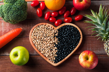 World food day, Top view of various fresh organic fruit and vegetable in heart plate, studio shot on wooden table, Healthy vegetarian food concept