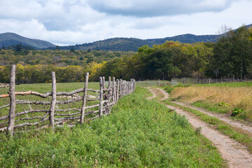 Fototapeta na wymiar wooden fence on a farm in the village