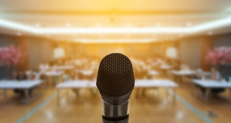 Microphone over the Abstract blurred photo of conference hall or seminar room with attendee...