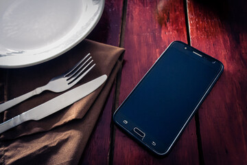 smartphone on casual table for dinner with friends